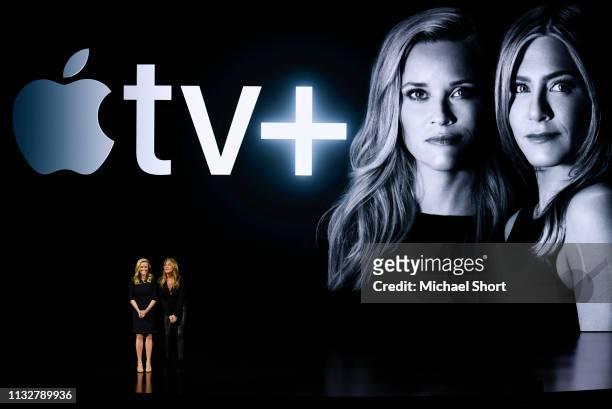 Actors Reese Witherspoon and Jennifer Aniston speak during an Apple product launch event at the Steve Jobs Theater at Apple Park on March 25, 2019 in...