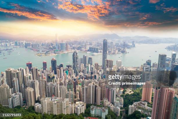 aerial view panoramic of the hong kong city skyline and victoria harbour at sunset at china - hong kong skyline drone stock pictures, royalty-free photos & images