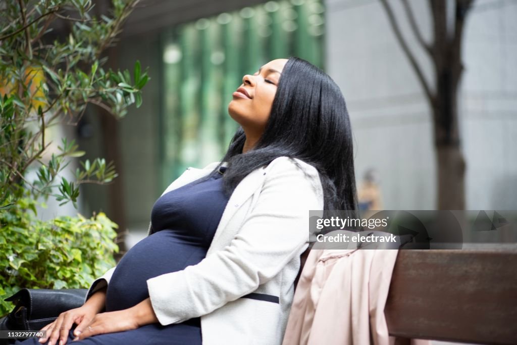 Pregnant woman sitting outside