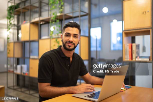 latin male portrait working with laptop at work studio - hispanic businessman stock pictures, royalty-free photos & images
