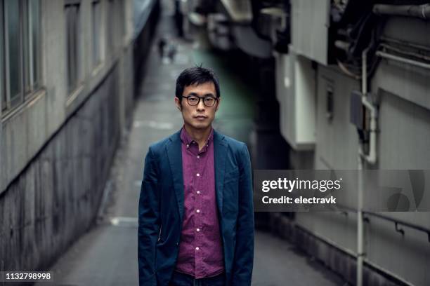 street portrait of mid adult man - red jacket stock pictures, royalty-free photos & images