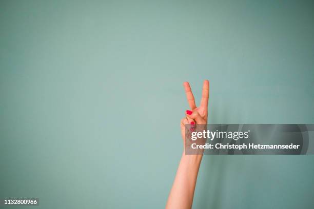 finger peace sign - symbols of peace stock pictures, royalty-free photos & images