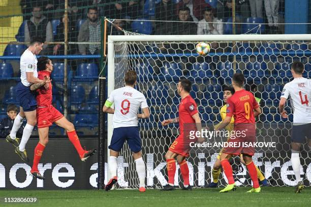 England's defender Michael Keane scores a goal during the Euro 2020 football qualification match between Montenegro and England at Podgorica City...