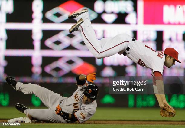 Second baseman Danny Espinosa of the Washington Nationals flips over Miguel Tejada of the San Francisco Giants after forcing him out at second base...