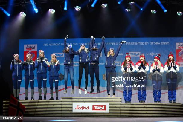 Norways Heidi Weng, Ingvild Flugstad Oestberg, Astrid Unrenholdt and Therese Johaug celebrate their silver medals, Swedens Ebba Andersson, Frida...