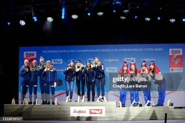 Norways Heidi Weng, Ingvild Flugstad Oestberg, Astrid Unrenholdt and Therese Johaug celebrate their silver medals, Swedens Ebba Andersson, Frida...