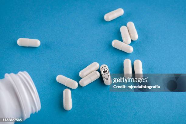pills spill out of pill bottle - antibiótico stock pictures, royalty-free photos & images