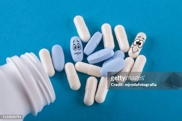 pills spill out of pill bottle - antibiótico stock pictures, royalty-free photos & images