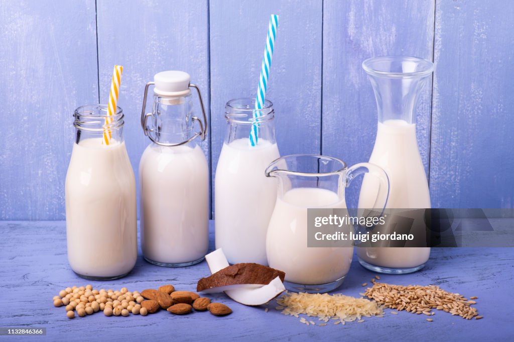 Various types of all-vegetable and organic milk in glass containers