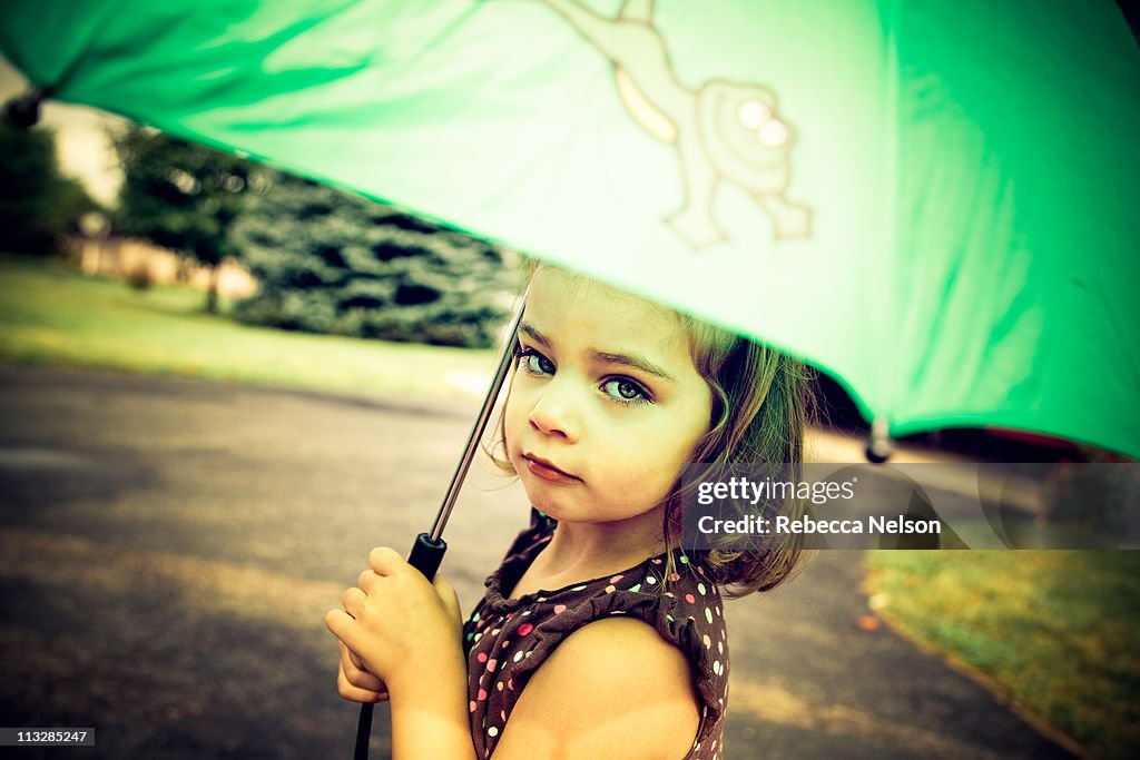 Young girl holding umbrella