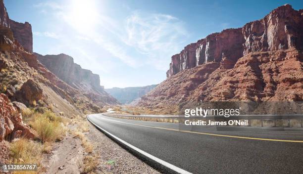 empty curved road in sandstone cliff valley - utah landscape stock pictures, royalty-free photos & images
