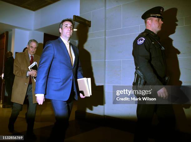 Michael Cohen, former attorney and fixer for President Donald Trump, and his lawyer Lanny Davis leave after Cohen testified at a closed door House...