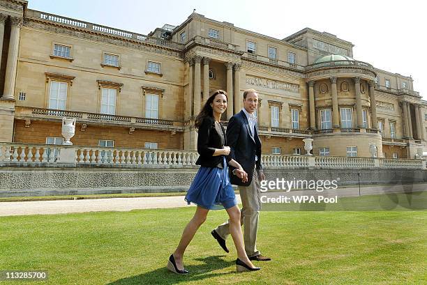Prince William, Duke of Cambridge and Catherine, Duchess of Cambridge walk hand in hand from Buckingham Palace the day after their wedding to a...