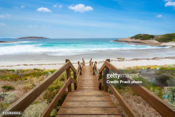 wooden jetty reaching into the salmon beach in esperance at western australia, australia. - westby stock pictures, royalty-free photos & images