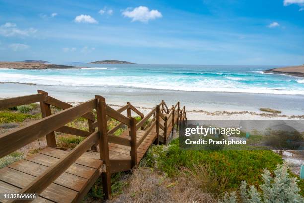 wooden jetty reaching into the salmon beach in esperance at western australia, australia. - westby stock pictures, royalty-free photos & images