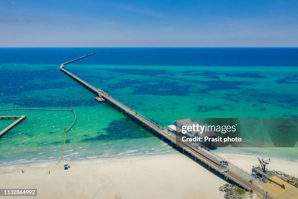 aerial view of busselton jetty on a sunny day with tourists in front of souvenir shop in busselton, western australia, australia. - busselton jetty stock pictures, royalty-free photos & images