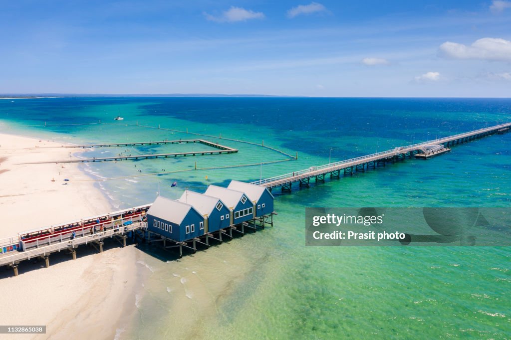Aerial view of Busselton Jetty on a sunny day with tourists in front of souvenir shop in Busselton, Western Australia, Australia.