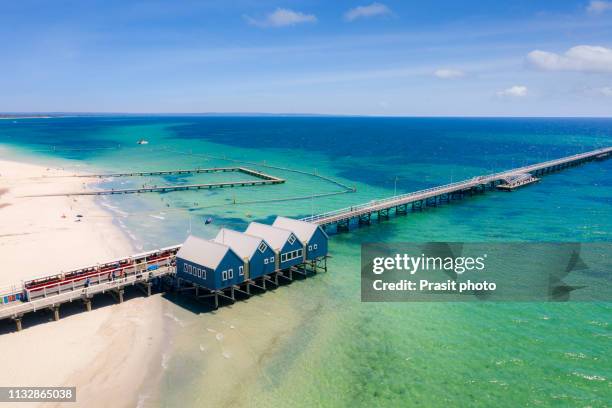 aerial view of busselton jetty on a sunny day with tourists in front of souvenir shop in busselton, western australia, australia. - perth photos et images de collection