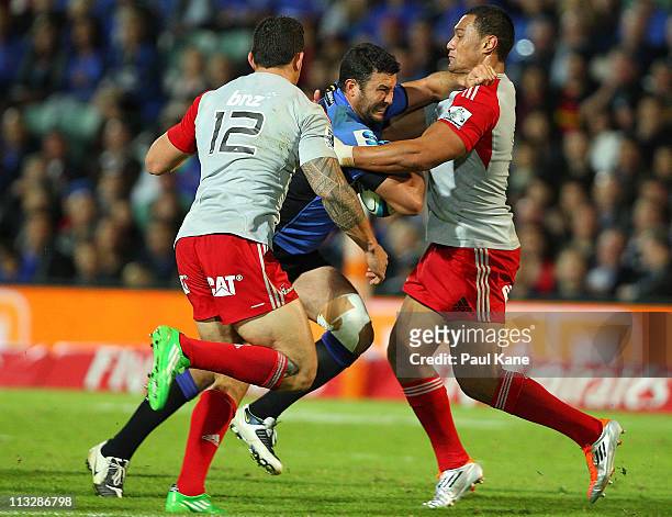 Cameron Shepherd of the Force looks to fend off Sonnybill Williams and Robbie Fruean of the Crusaders during the round 11 Super Rugby match between...