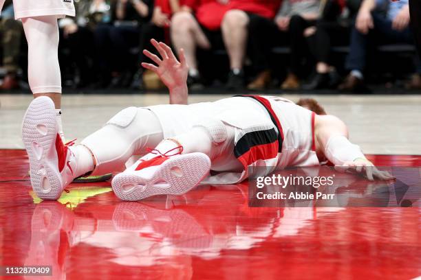 Jusuf Nurkic of the Portland Trail Blazers reacts after suffering an apparent broken leg against the Brooklyn Nets in double overtime during their...