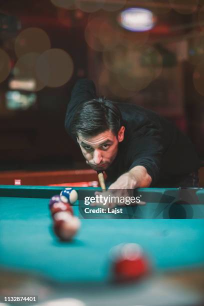 man playing pool in bar - shooting pool stock pictures, royalty-free photos & images