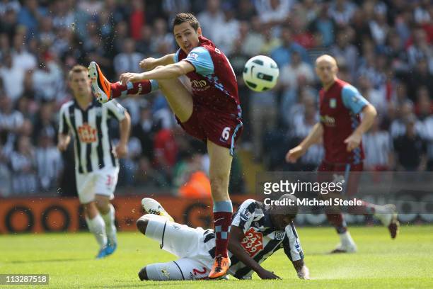 Stewart Downing of Villa hurdles above the challenge from Youssouf Mulumbu during the Barclays Premier League match between West Bromwich Albion and...