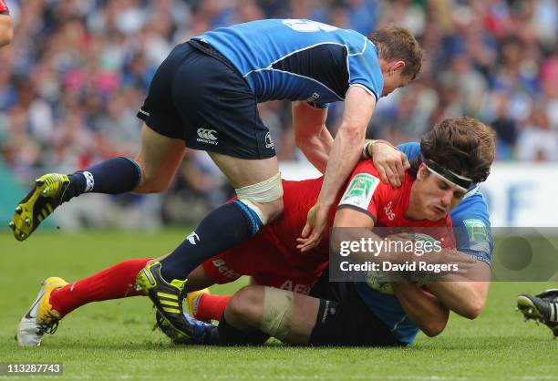 David Skrela of Toulouse is tackled by Brian O'Driscoll and Jamie Heaslip during the Heineken Cup semi final match between Leinster and Toulouse at...