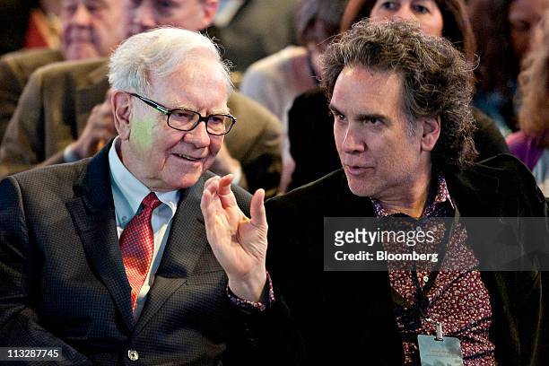 Warren Buffett, chairman of Berkshire Hathaway Inc., left, talks with his son Peter Buffett, prior to the start of the Berkshire Hathaway...