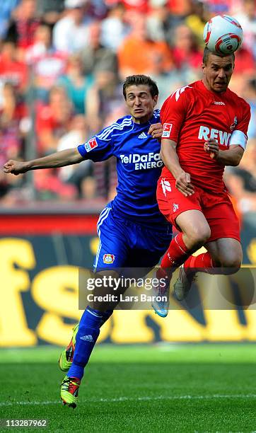 Daniel Schwaab of Leverkusen pushes Lukas Podolski of Koeln during the Bundesliga match between 1. FC Koeln and Bayer Leverkusen at...