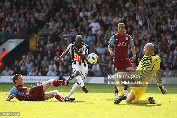 Youssouf Mulumbu of West Brom scores the winning goal as Ciaran Clark and goalkeeper Brad Friedel close in during the Barclays Premier League match...