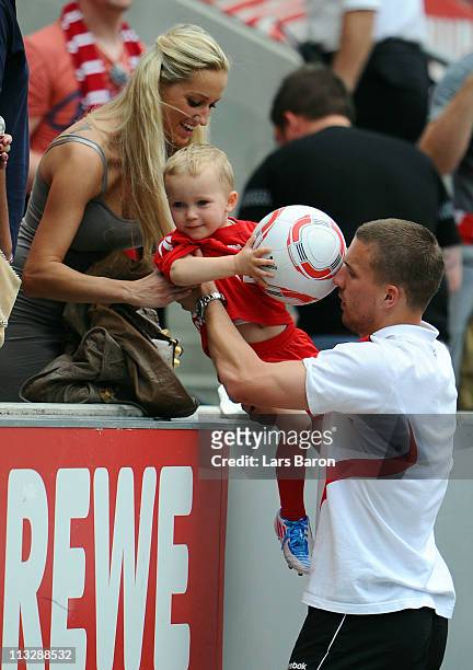 Lukas Podolski of Koeln is seen with his wife Monika and son Louis after winning the Bundesliga match between 1. FC Koeln and Bayer Leverkusen at...
