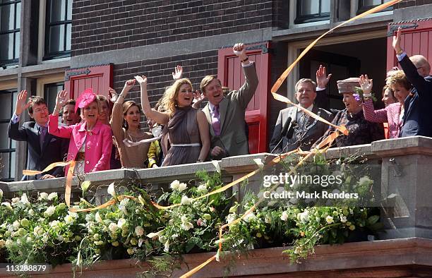 Princess Maxima of The Netherlands, Prince Willem Alexander of The Netherlands and Queen Beatrix of The Netherlands wave from the Townhall balcony...