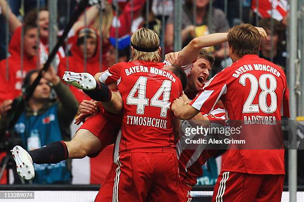 Thomas Mueller of Muenchen celebrates his team's third goal with team mates during the Bundesliga match between FC Bayern Muenchen and FC Schalke 04...
