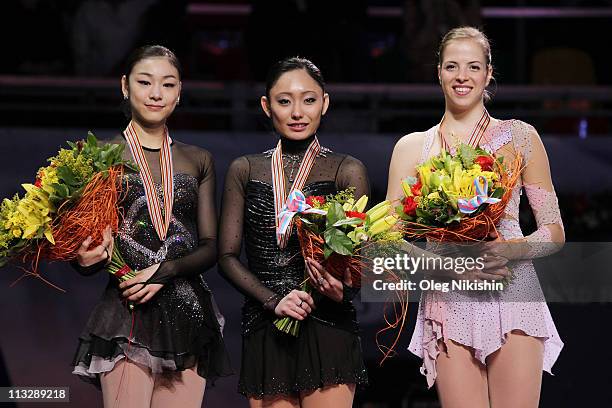 Yuna Kim of Korea , Miki Ando of Japan and Carolina Kostner of Italy smile on the podium after winning the ladies's event of the ISU World Figure...