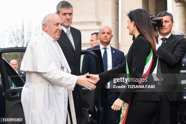 Rome mayor Virginia Raggi greets Pope Francis upon his arrival for a visit at Rome's City Hall on Capitoline Hill on March 26, 2019.