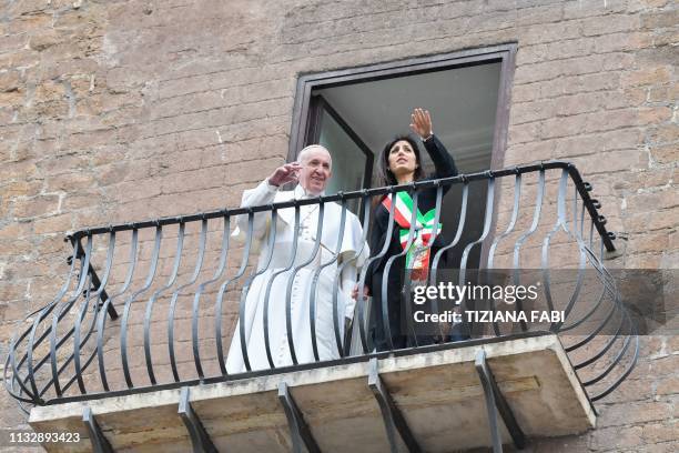 Rome mayor Virginia Raggi shows Pope Francis the view over the Roman Forum from a balcony during the Pope's visit to Rome's City Hall on Capitoline...