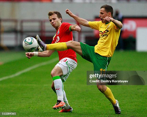 Roman Shishkin of FC Lokomotiv Moscow battles for the ball with Gheorghe Bucur of FC Kuban Krasnodar during the Russian Football League Championship...