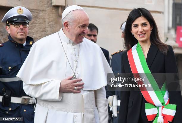 Rome mayor Virginia Raggi greets Pope Francis upon his arrival for a visit at Rome's City Hall on Capitoline Hill on March 26, 2019.