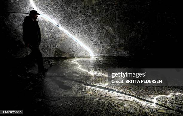 Visitor walks over an interactive map of Berlin where are marked the course of the Berlin Wall and sites relating to the "Stasi", the former East...