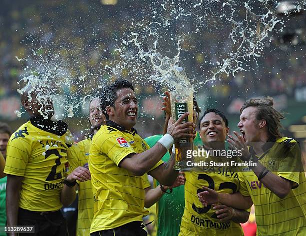 Lucas Barrios, Kevin Grosskreutz, Antonio Da Silva and Felipe Santana of Dortmund celebrates winning the league title at the end of the Bundesliga...