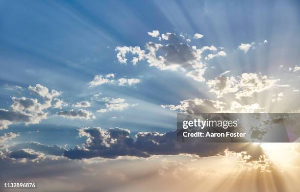 sunset behind clouds - vista posterior stock pictures, royalty-free photos & images