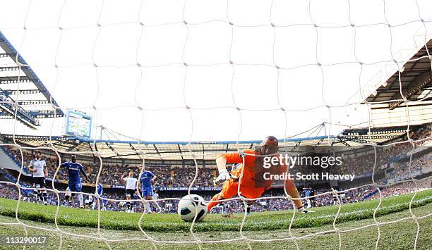 Heurelho Gomes of Spurs attempts to save the shot from Frank Lampard of Chelsea during the Barclays Premier League match between Chelsea and...