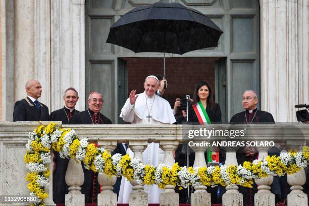 Pope Francis waves after delivering an address from Rome's City Hall during a visit to Rome mayor Virginia Raggi on Capitoline Hill on March 26 as...