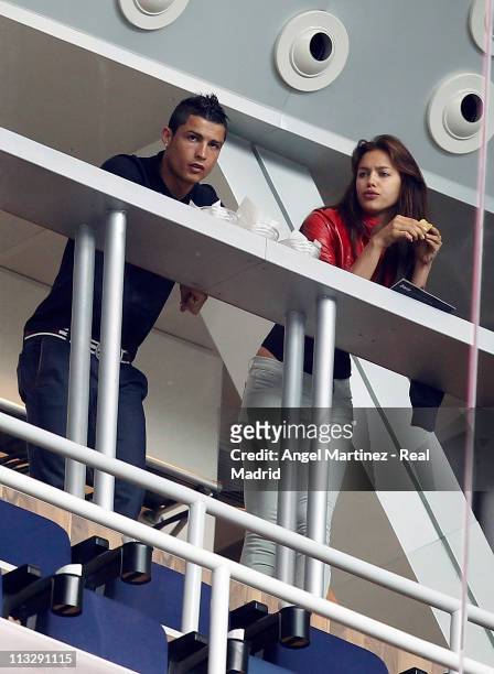 Cristiano Ronaldo of Real Madrid looks on next to his girlfriend Irina Shayk before the La Liga match between Real Madrid and Real Zaragoza at...