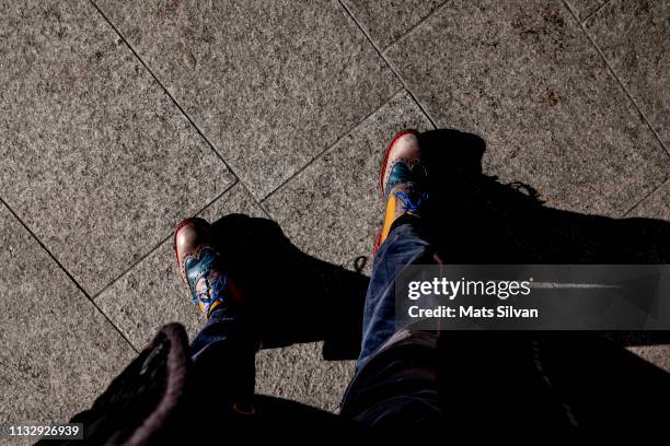 man with colorful shoes - different perspective stock-fotos und bilder