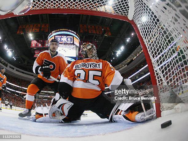 Shot by Gregory Campbell of the Boston Bruins eludes Sergei Bobrovsky of the Philadelphia Flyers late in the third period in Game One of the Eastern...