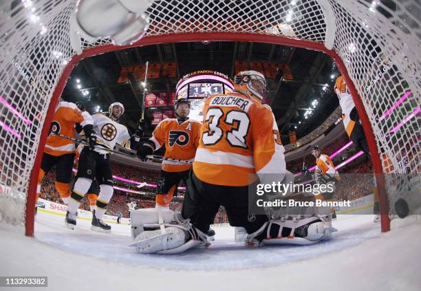 Shot by Nathan Horton of the Boston Bruins hits the net at 19:24 of the first period as David Krejci watches on and Kimmo Timonen and Brian Boucher...