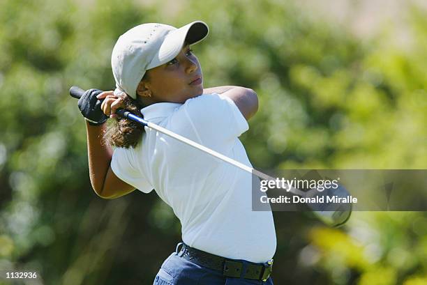 Cheyenne Woods, niece of Tiger Woods, tees off the 10th hole during the 2nd Round of the Junior World Golf Championships on July 17, 2002 at the...