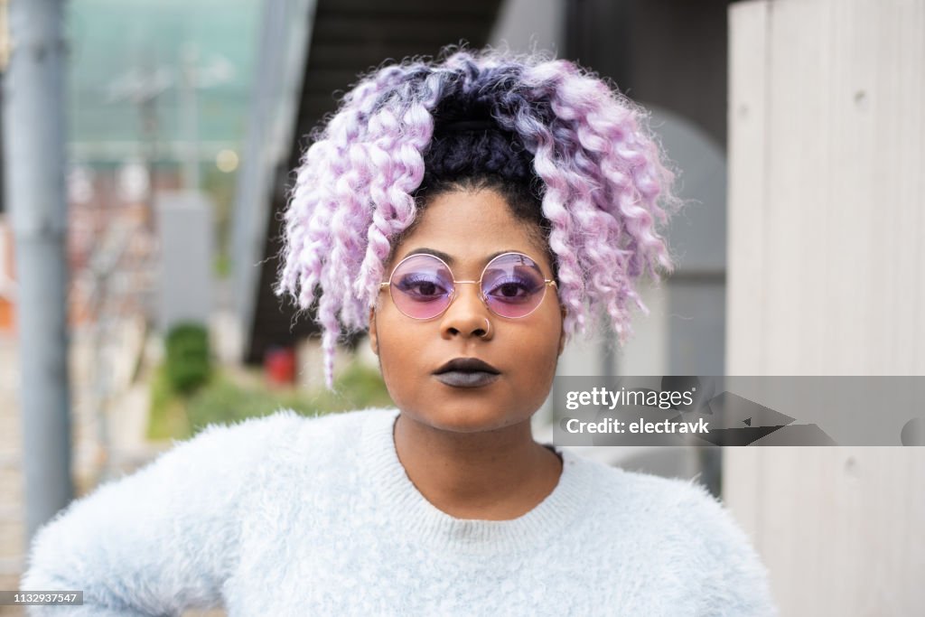 Street portrait of young woman with purple hair
