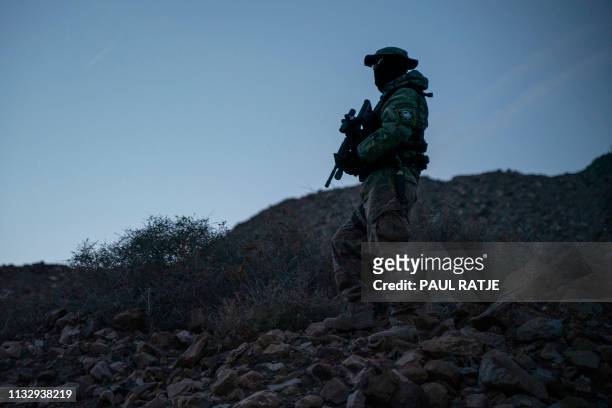 Stinger, a member of Constitutional Patriots New Mexico Border Ops Team militia is pictured on patrol at the US-Mexico border near Mt. Christo Rey in...